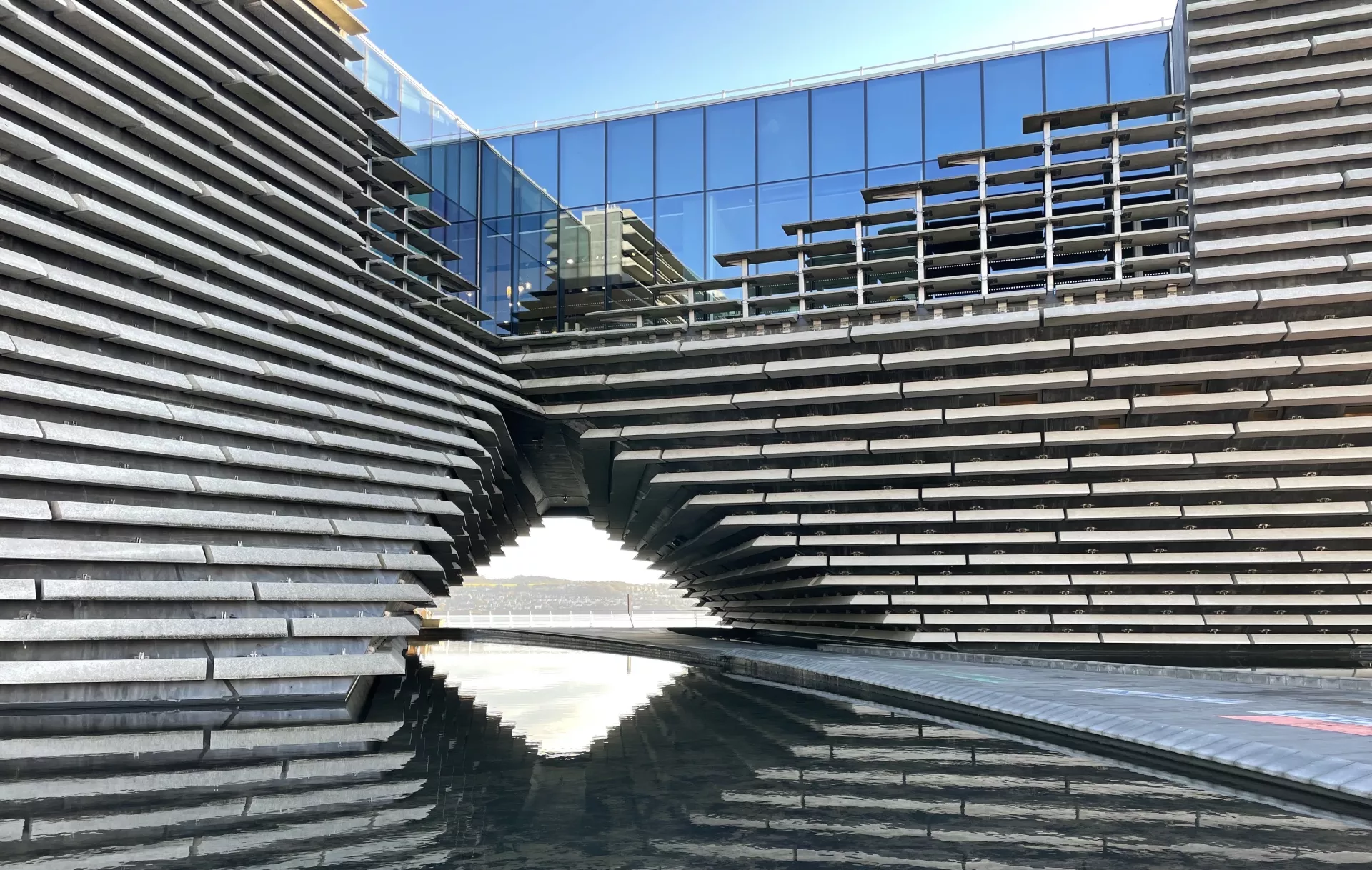 I finally got to the V & A in Dundee. I wanted to see Kengo Kuma’s architecture, and take photos. His design was inspired by the eastern coastline of Scotland. These cladded horizontal concrete panels, with the walkway in the centre, felt like I was looking through a kaleidoscope. I asked a few people to stop, so I could capture the walkway empty, where You could literally see to the other side of the Tay.